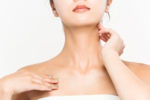 A woman has skincare on her neck.