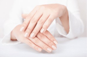 woman hands applying moisturizing cream to her skin