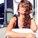 young happy pretty woman laughing and having fun on the street at nice sunny summer day