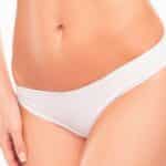 Close up photo of woman's belly and white panties