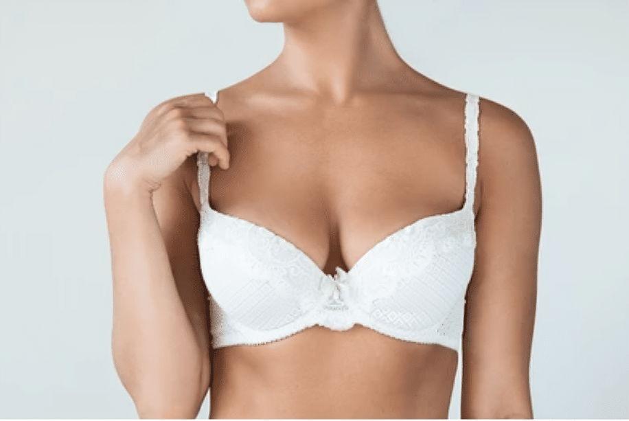 Cropped shot of woman in white bra after breast lift and implant removal
